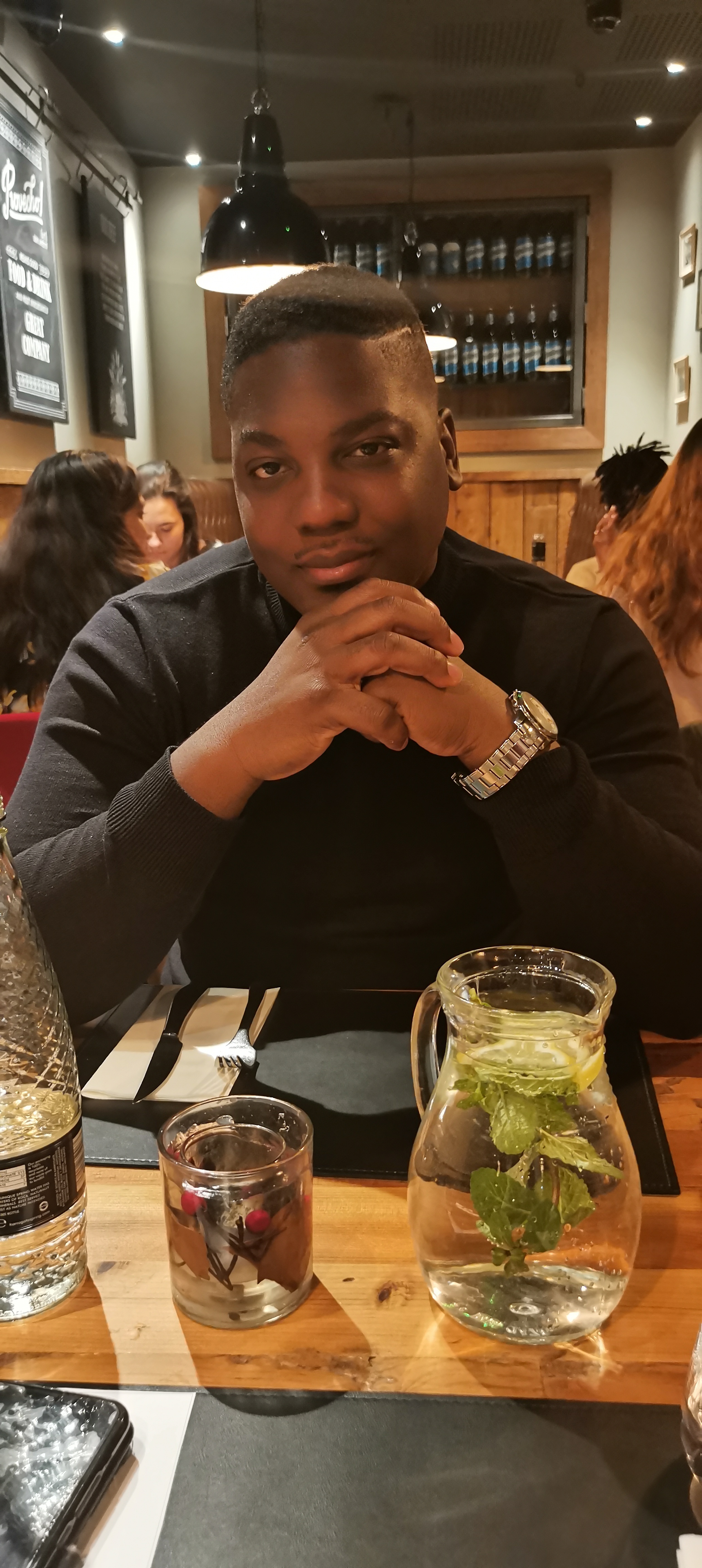 I am sitting at a table staring at you with my hand resting on my chin